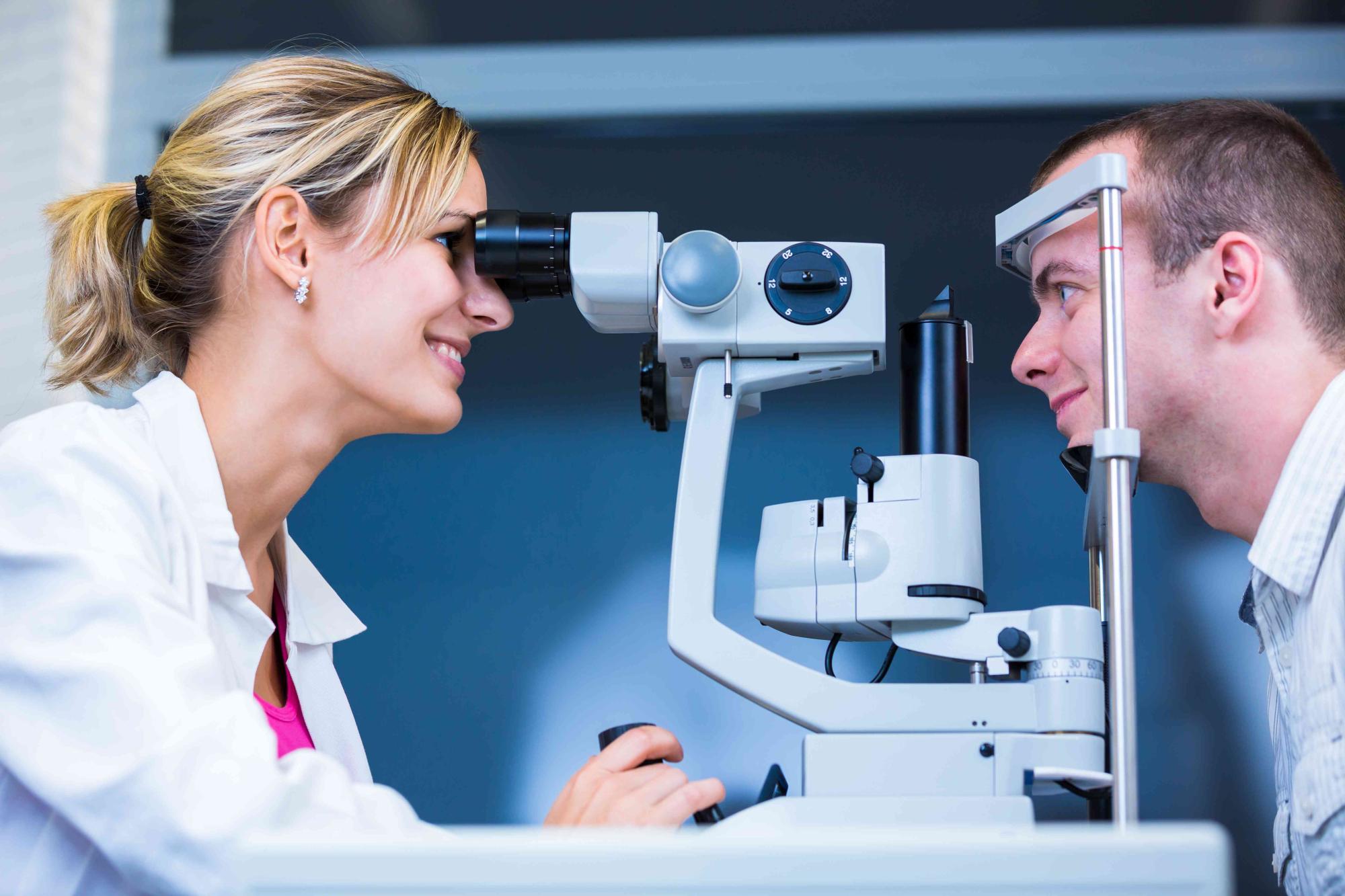 Eye care professional performing a slit lamp examination on a patient